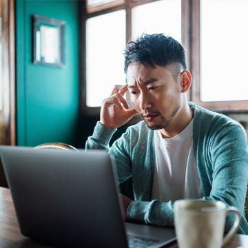 Concerned man reading the latest news about spoofing attempts